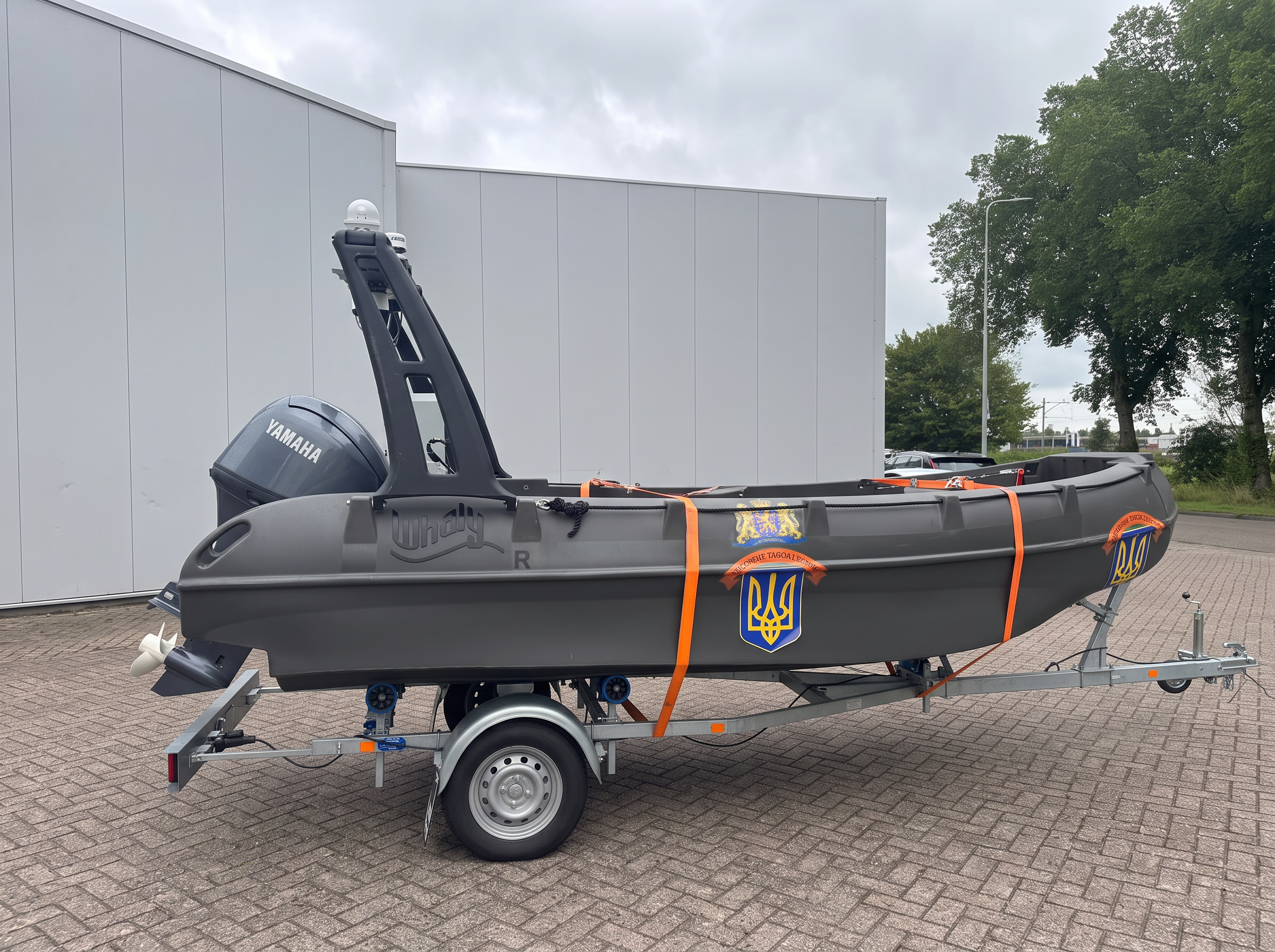 River Whale USV lashed on its single-axle road trailer outside the workshop